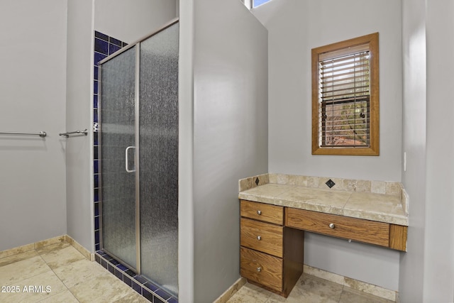 full bathroom with baseboards and a stall shower