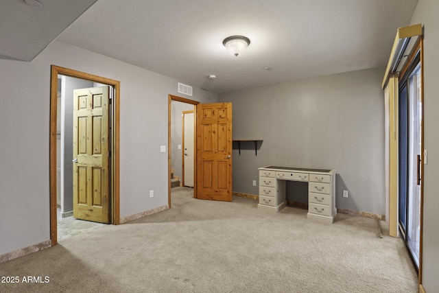 unfurnished bedroom with visible vents, carpet floors, and baseboards