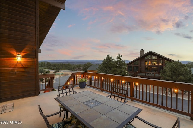 patio terrace at dusk featuring outdoor dining area