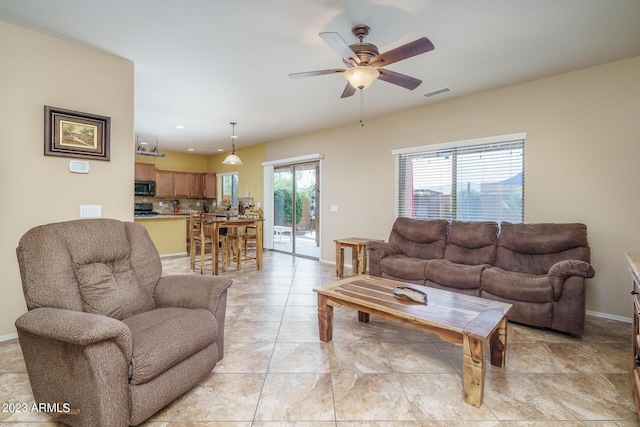 living room with ceiling fan and light tile patterned floors