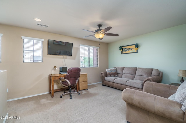 carpeted office with ceiling fan