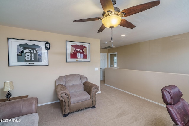 sitting room featuring light colored carpet