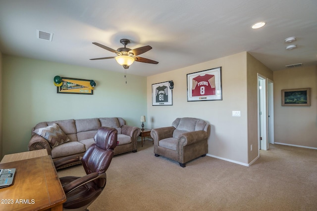 carpeted living room with ceiling fan