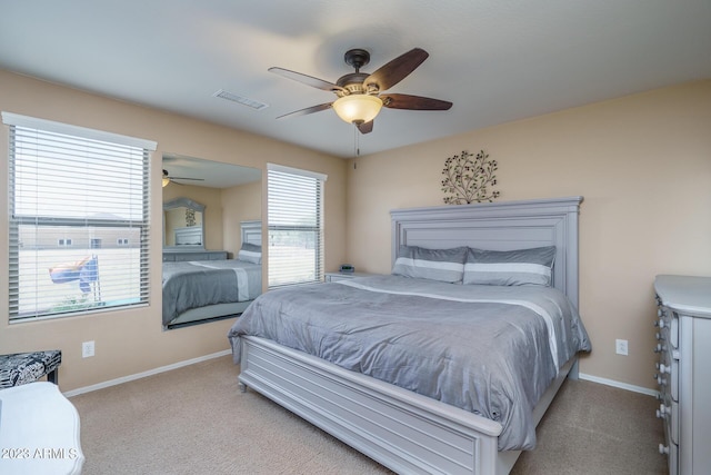 bedroom with ceiling fan and light colored carpet