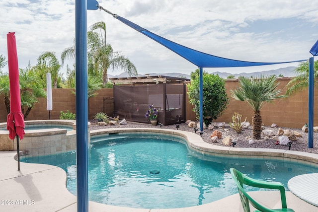 view of pool with an in ground hot tub