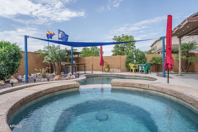 view of pool with an in ground hot tub