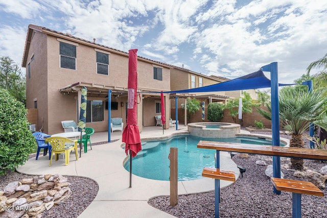 view of pool with a patio and an in ground hot tub