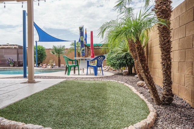 view of yard featuring a fenced in pool and a patio area