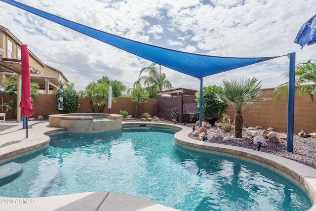 view of swimming pool with an in ground hot tub