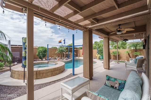 view of patio with ceiling fan, a swimming pool with hot tub, and an outdoor hangout area