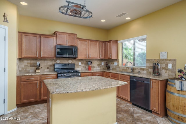 kitchen with sink, gas range, a center island, black dishwasher, and decorative backsplash