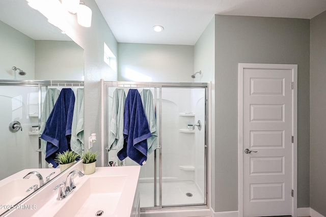 bathroom featuring walk in shower and vanity