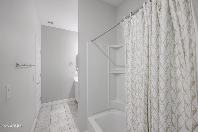 bathroom with tile patterned flooring, vanity, and shower / bath combo with shower curtain