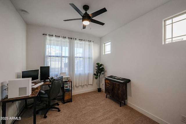 home office featuring ceiling fan and light carpet