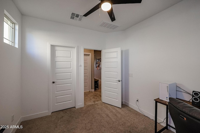 bedroom featuring light colored carpet and ceiling fan