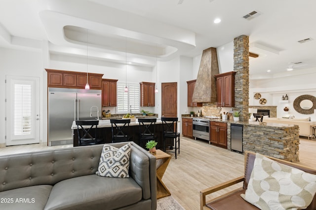 6146 E Dixileta Dr, Cave Creek, AZ 85331 - living area featuring visible vents, a raised ceiling, a high ceiling, and light wood-type flooring