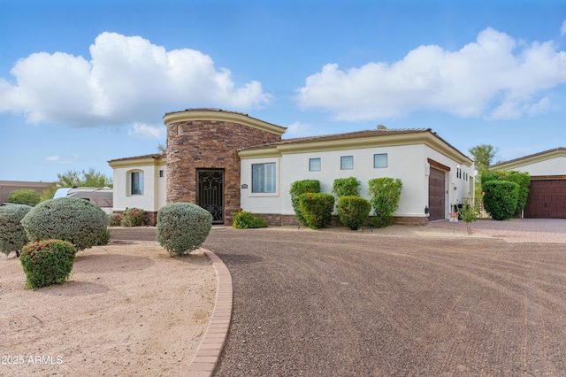 6146 E Dixileta Dr, Cave Creek, AZ 85331 - view of front of property with an attached garage, stucco siding, and stone siding