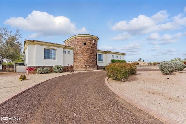 6146 E Dixileta Dr, Cave Creek, AZ 85331 - view of front facade with stucco siding, fence, and stone siding