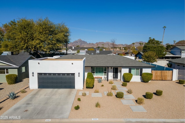 view of front of home with a garage and a mountain view