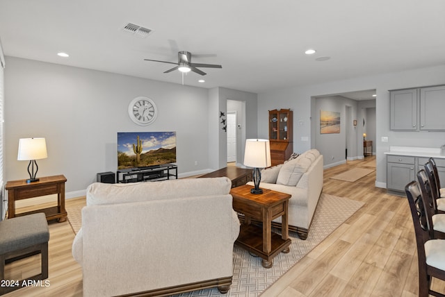 living room featuring light wood-type flooring and ceiling fan