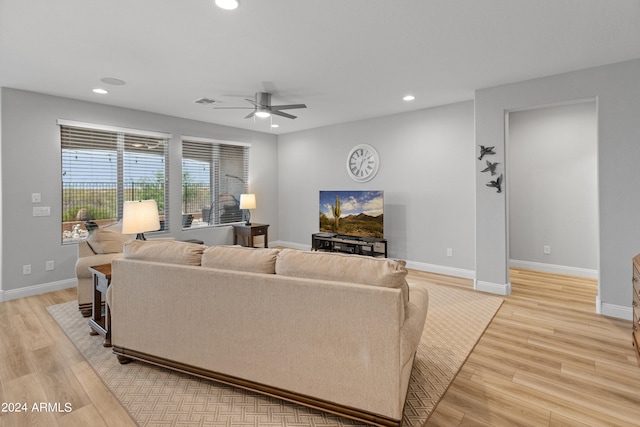 living room featuring ceiling fan and light hardwood / wood-style floors