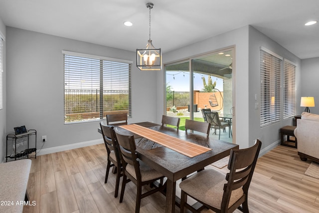 dining space featuring light hardwood / wood-style flooring and a chandelier