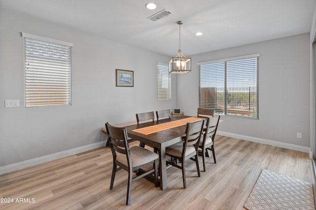 dining area featuring an inviting chandelier and light hardwood / wood-style floors