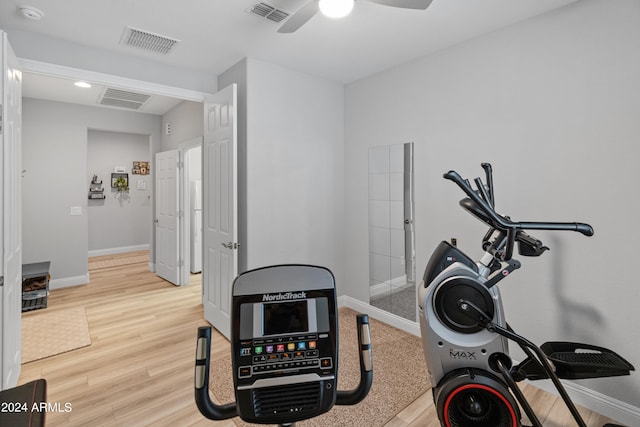 workout area with ceiling fan and light hardwood / wood-style floors