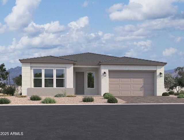 view of front facade with an attached garage, a tile roof, decorative driveway, and stucco siding