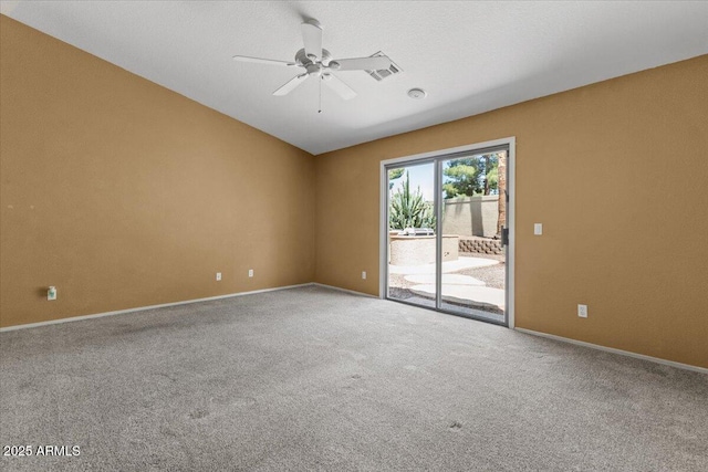 carpeted spare room with vaulted ceiling, baseboards, a ceiling fan, and visible vents