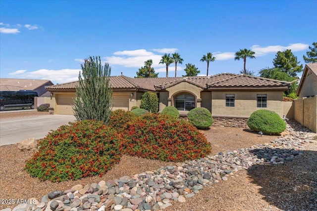 ranch-style home featuring fence, a tile roof, a garage, stucco siding, and concrete driveway