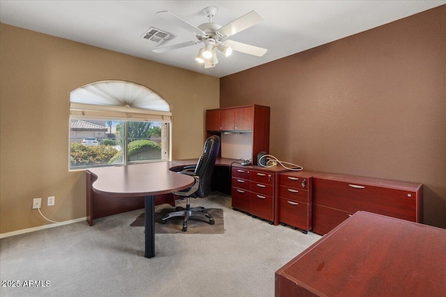 office space with ceiling fan, visible vents, light carpet, and baseboards