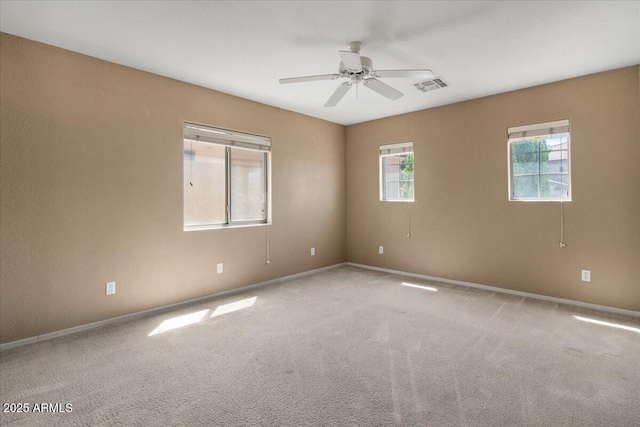 unfurnished room with visible vents, baseboards, carpet floors, and ceiling fan