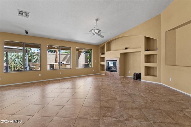 unfurnished living room featuring visible vents, built in features, baseboards, tile patterned floors, and a ceiling fan