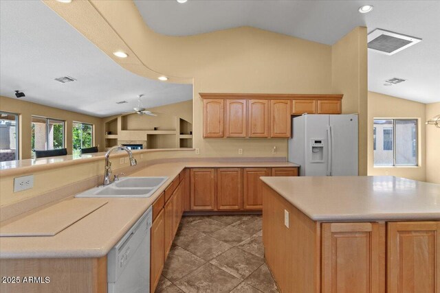 kitchen featuring a sink, white appliances, a ceiling fan, lofted ceiling, and visible vents