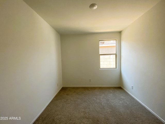 carpeted spare room with baseboards