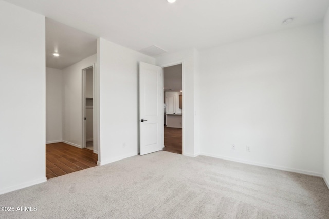 unfurnished bedroom featuring recessed lighting, carpet, and baseboards