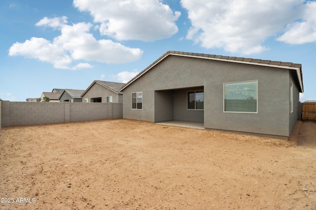 back of property featuring a patio, a fenced backyard, and stucco siding