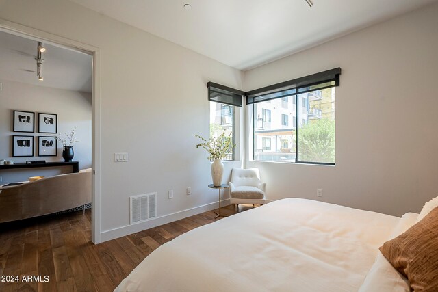 bedroom with dark hardwood / wood-style floors