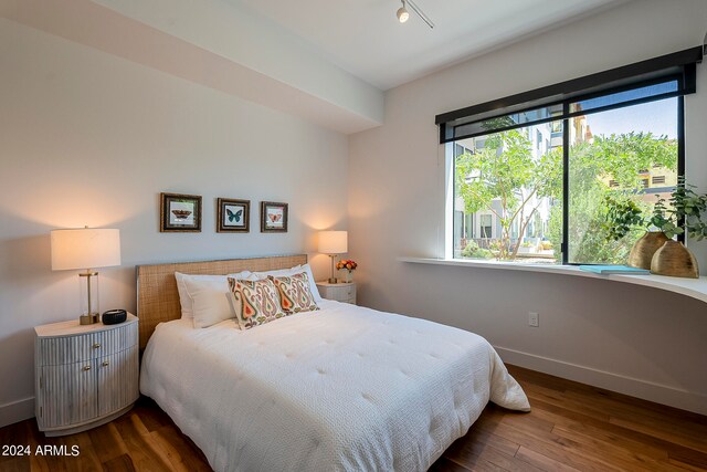 bedroom with dark wood-type flooring