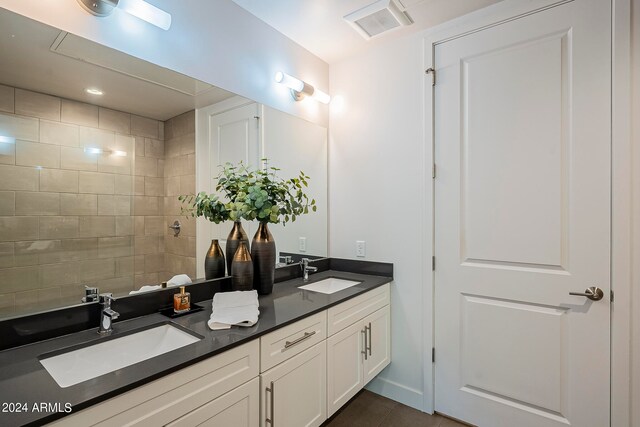 bathroom with tile floors, dual sinks, and large vanity