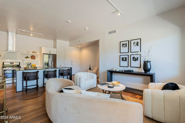 living room featuring track lighting and dark wood-type flooring