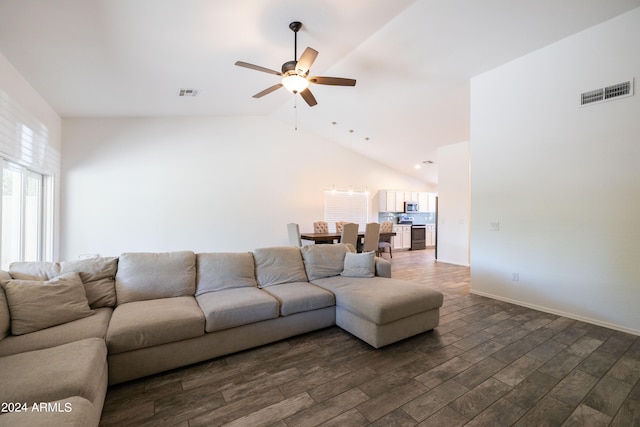 living room featuring dark hardwood / wood-style floors, high vaulted ceiling, and ceiling fan