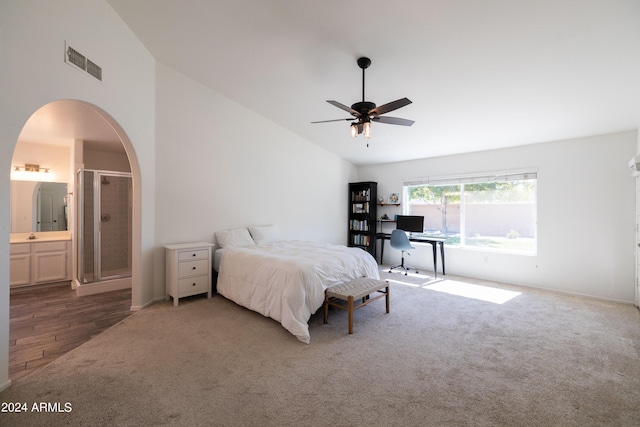 bedroom with connected bathroom, ceiling fan, vaulted ceiling, and dark hardwood / wood-style floors