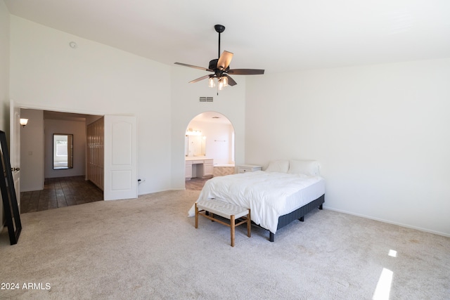 bedroom featuring ensuite bathroom, carpet floors, and ceiling fan