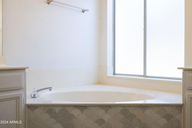 bathroom with vanity and a tub