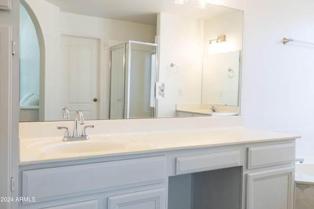 bathroom with vanity and a shower with shower door