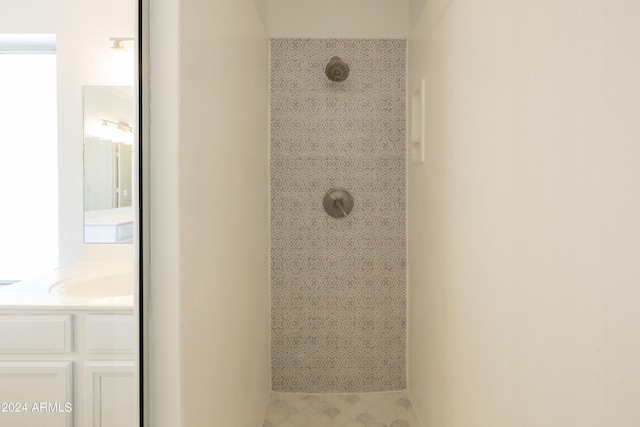 bathroom featuring vanity and tiled shower