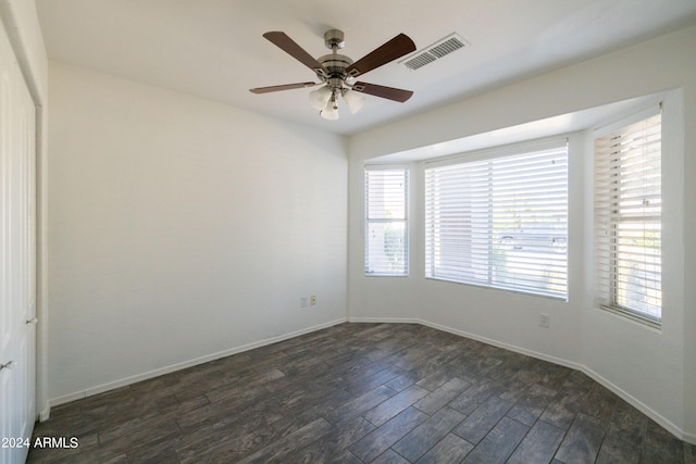 spare room featuring dark hardwood / wood-style floors and ceiling fan