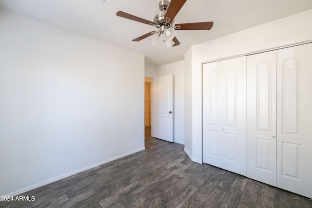 unfurnished bedroom with a closet, ceiling fan, and dark hardwood / wood-style flooring